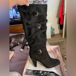 Heeled boots. Black color.  Size 11. Never worn